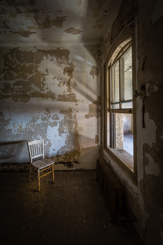 Sunlit chair facing an open window